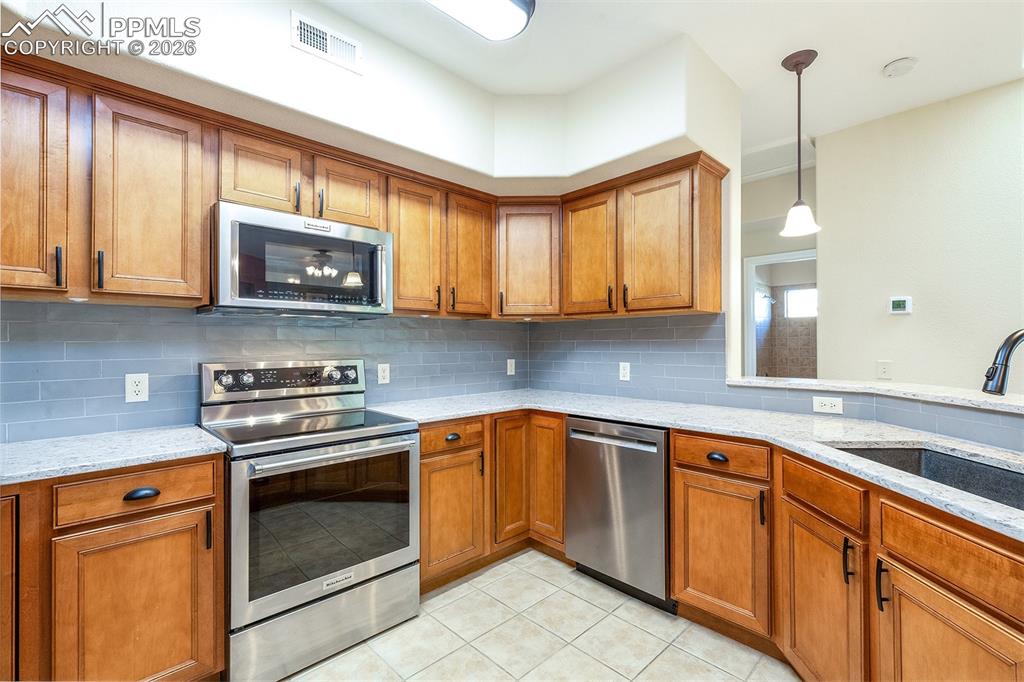 Image 10 of 23: Granite countertops and tile backsplash