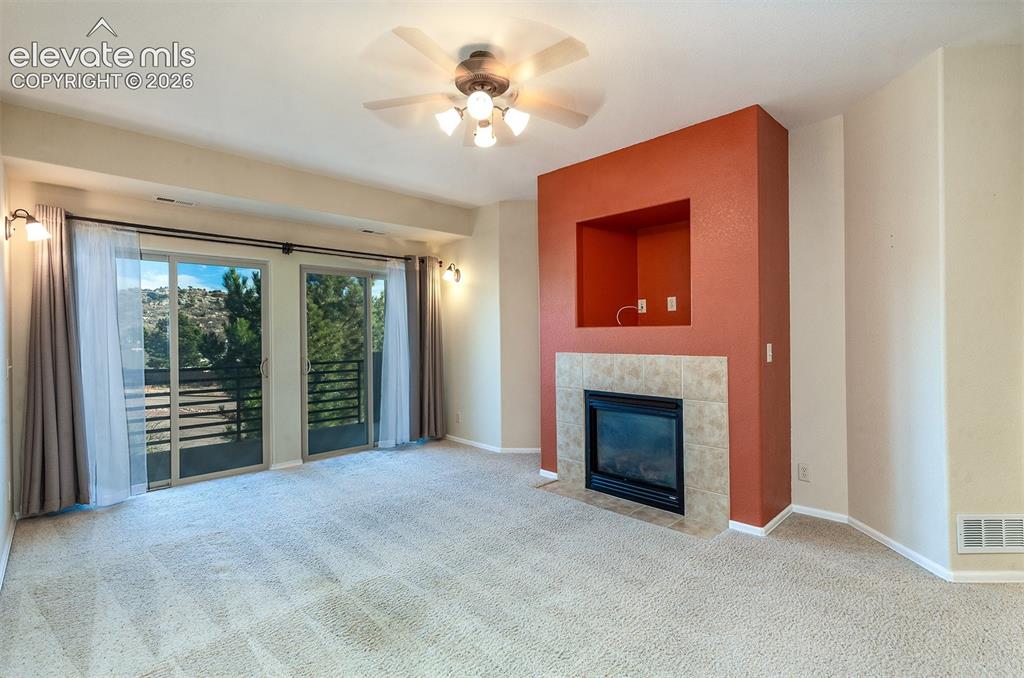 Image 11 of 23: Gas fireplace and walkout to private balcony.