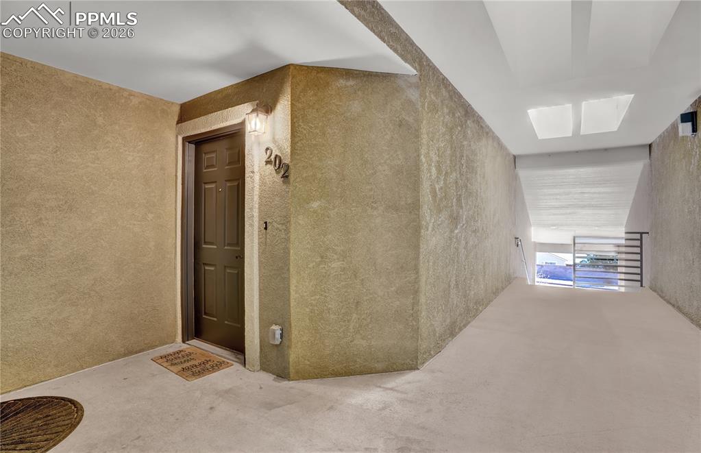 Image 2 of 23: Covered hallways and entrance on 2nd level