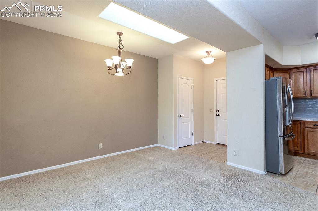 Image 5 of 23: Dining area just off kitchen with skylight