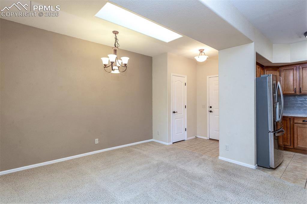 Image 5 of 23: Dining area just off kitchen with skylight