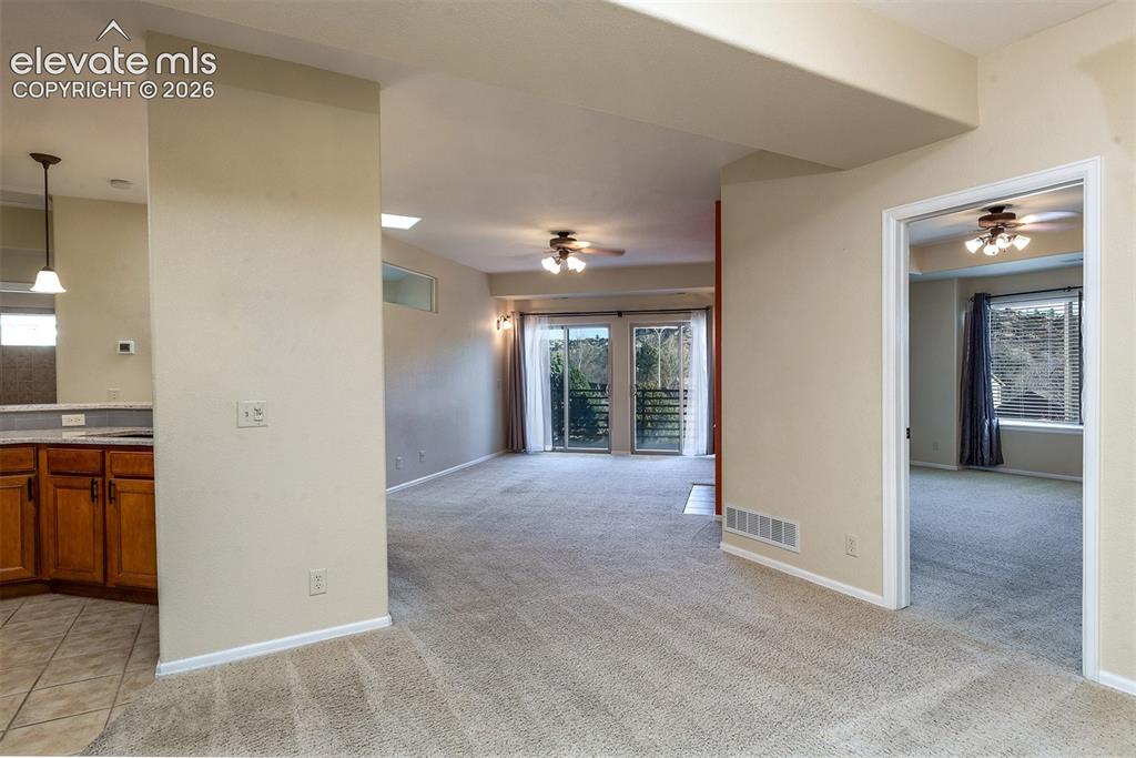 Image 7 of 23: Primary bedroom (right), living area, and kitchen (left) upon entry