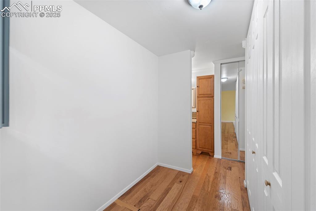 Image 15 of 23: Hallway with light wood finished floors and baseboards