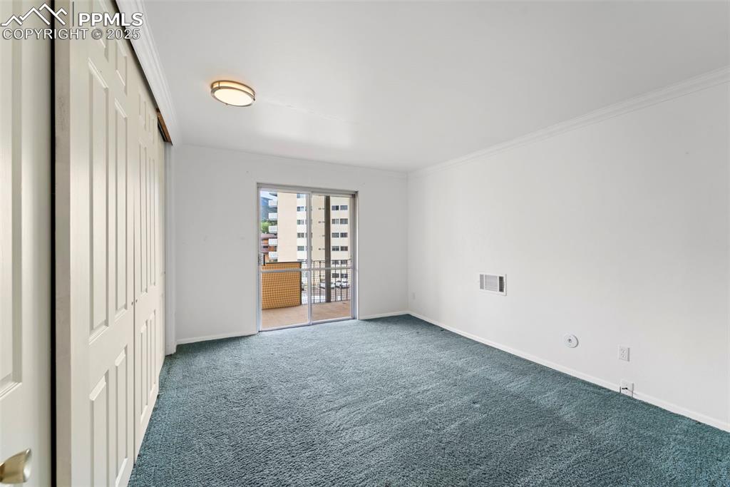Image 18 of 23: Unfurnished room featuring carpet floors and ornamental molding