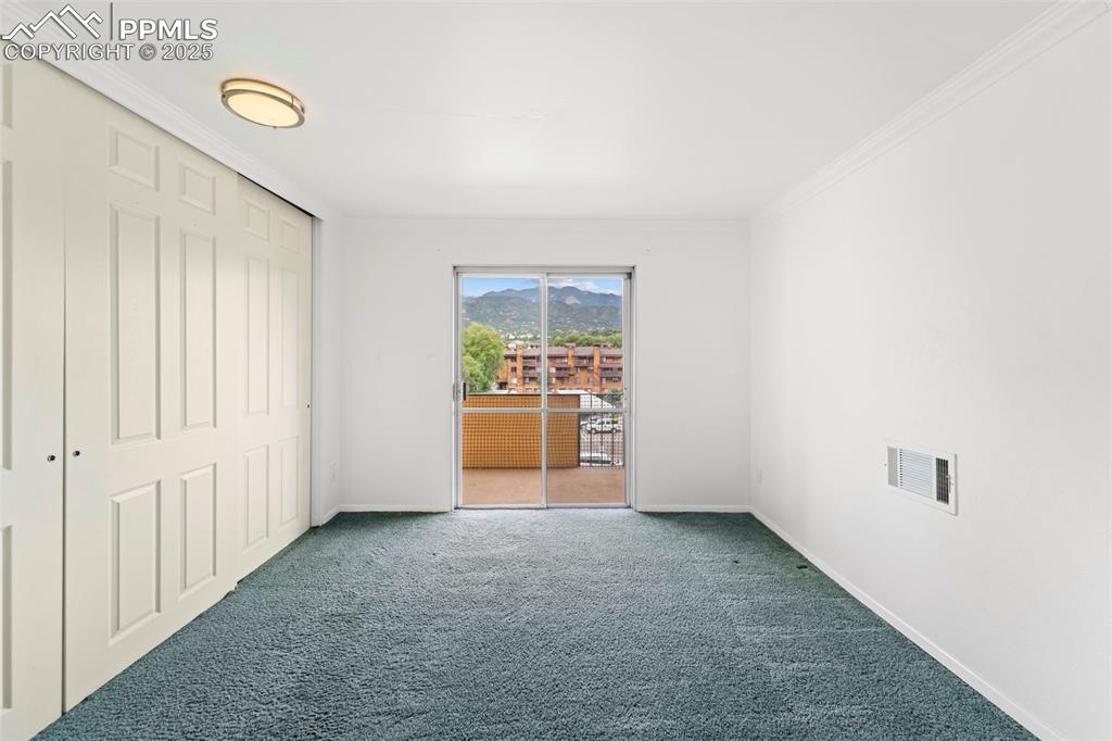 Image 19 of 23: Unfurnished bedroom with carpet floors, ornamental molding, access to outsi