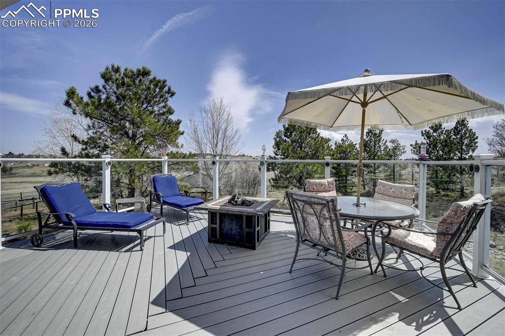 Image 11 of 50: Glass paneled deck with firepit