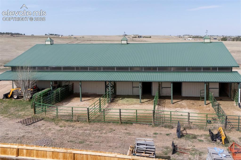 Image 39 of 50: 50x100 metal drive-through barn has a concrete floor, w/ a half bath, 4 sta