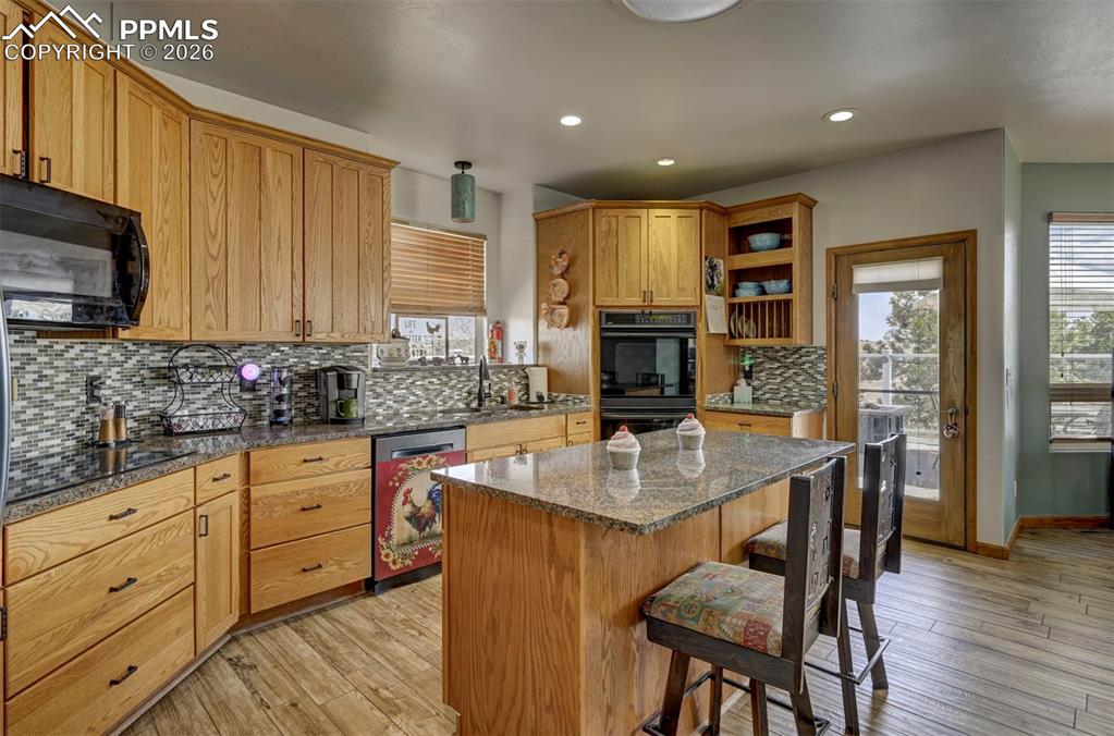 Image 8 of 50: Kitchen with ceramic tile flooring, granite counters, plenty of cabinet spa