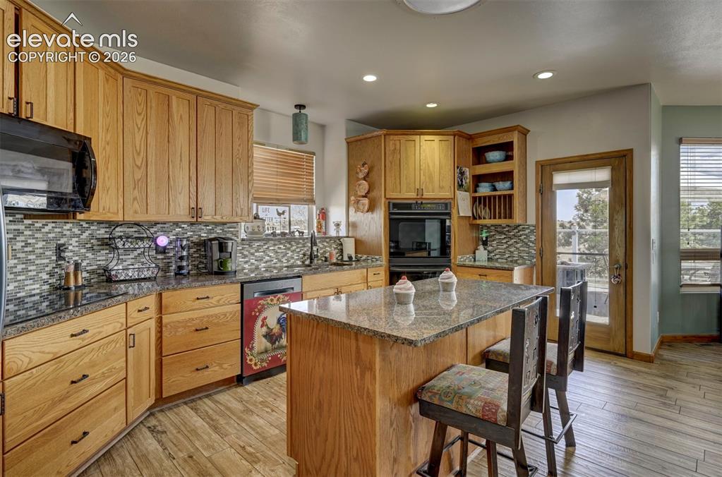 Image 8 of 50: Kitchen with ceramic tile flooring, granite counters, plenty of cabinet spa