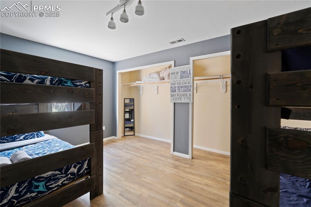 Image 25 of 37: Lower Level Bedroom with Engineered-wood Flooring!