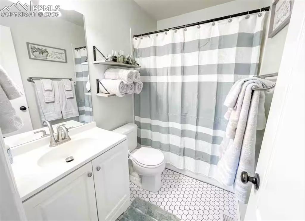 Image 9 of 37: Main Level Full Bath with pretty chic tile flooring!