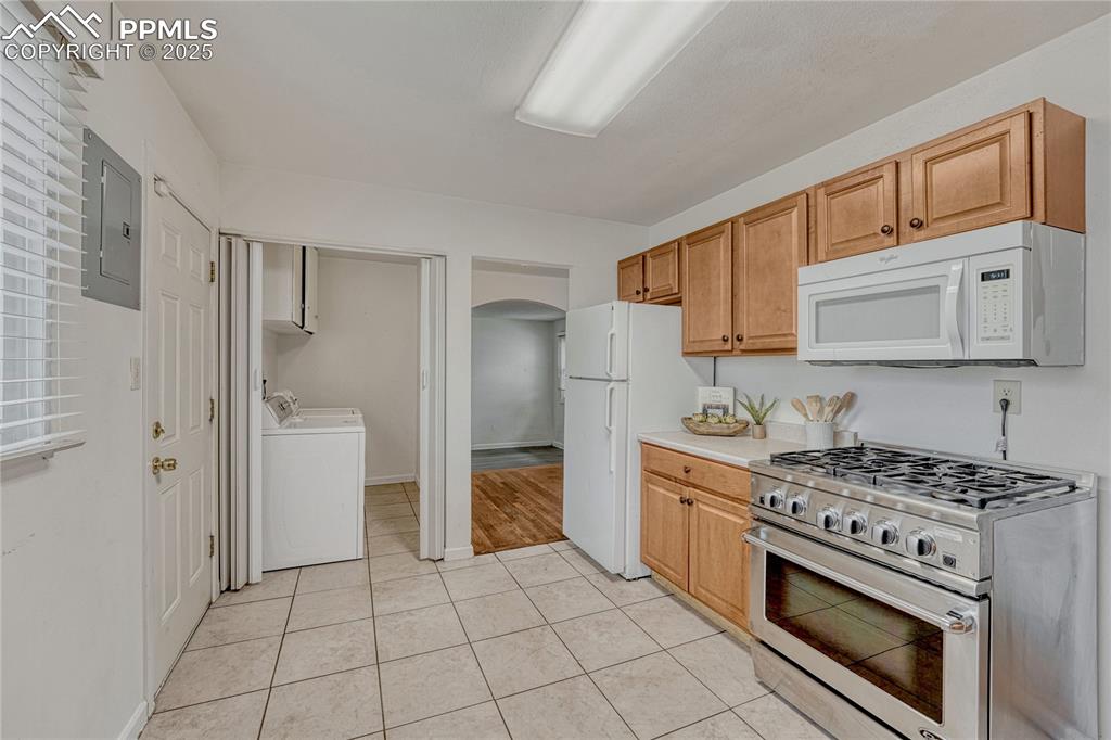 Image 24 of 43: Laundry room is perfectly placed off of the kitchen