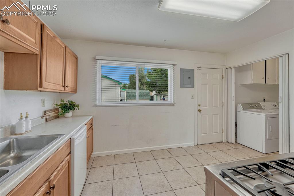 Image 26 of 43: Kitchen has a large window and provides a walk out to the back porch