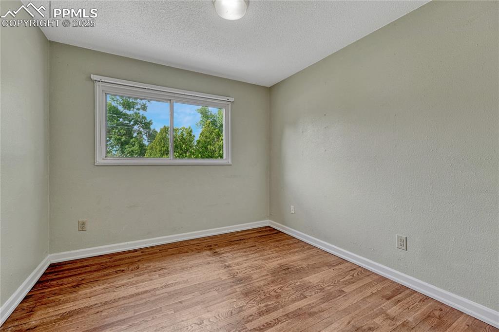 Image 30 of 43: Bedroom #2 with hardwood flooring