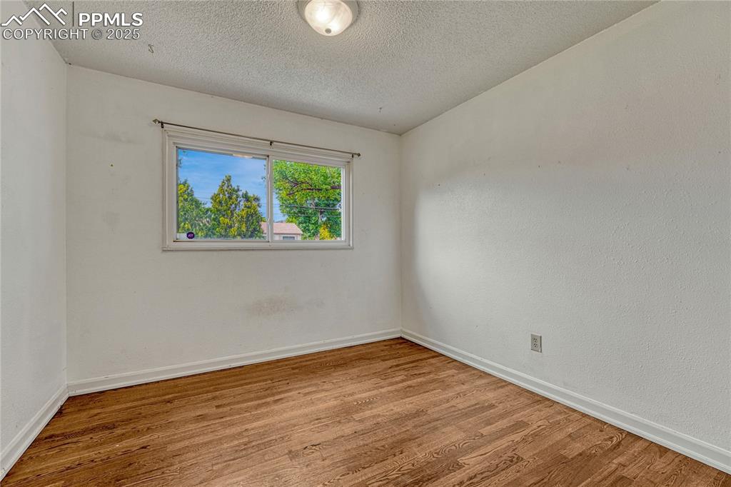Image 32 of 43: Bedroom #3 with hardwood flooring
