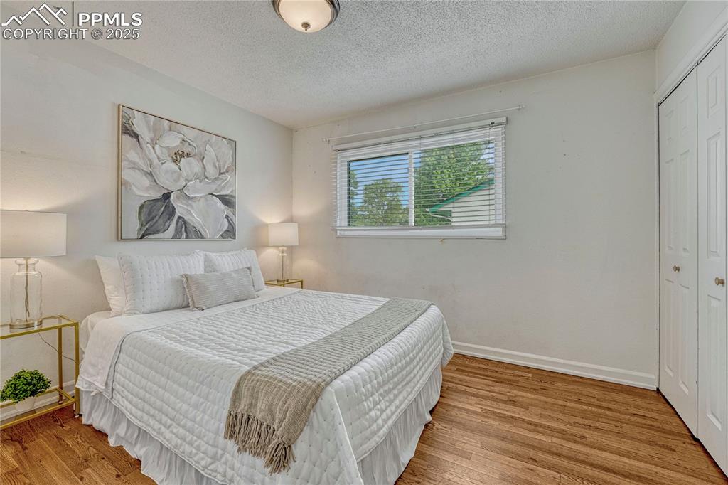 Image 6 of 43: Primary bedroom with hardwood flooring