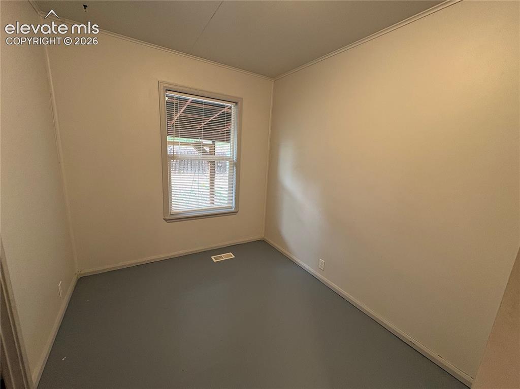 Image 10 of 12: Neutral wall paint, window with blinds, light-colored trim, and painted flo