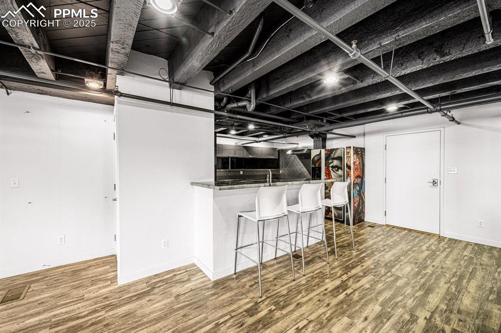 Image 11 of 32: Kitchen featuring wood finished floors and breakfast bar