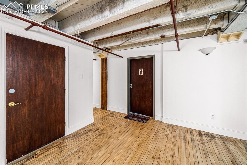 Image 32 of 32: Finished below grade area with baseboards and light wood-style floors