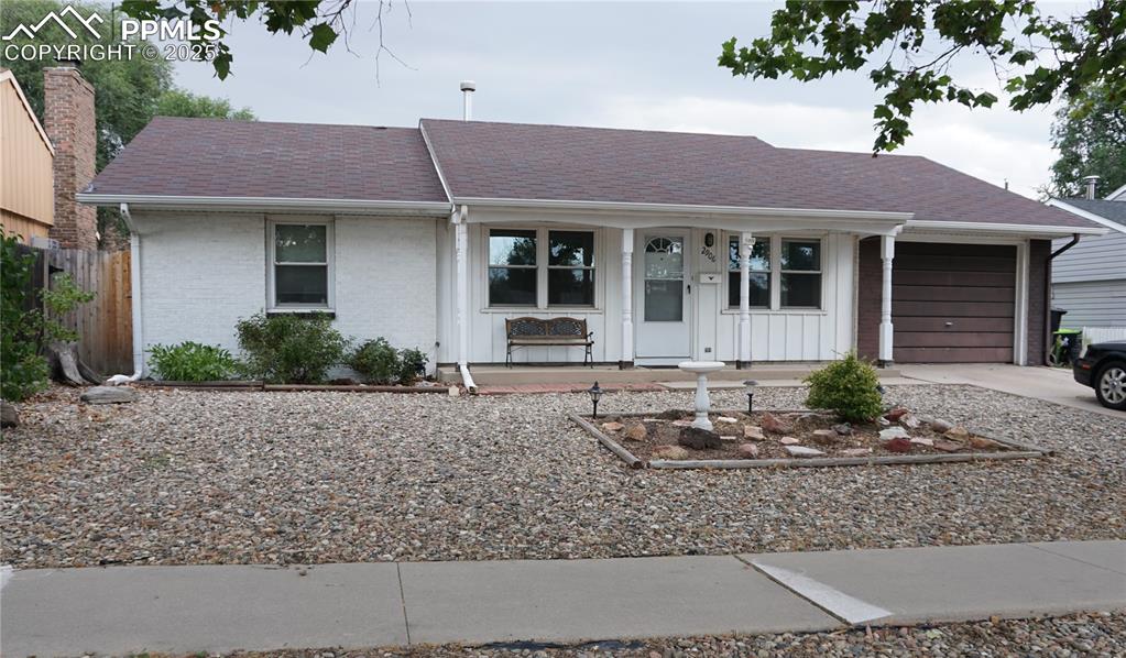 Caption: Covered front porch and an oversized one car garage