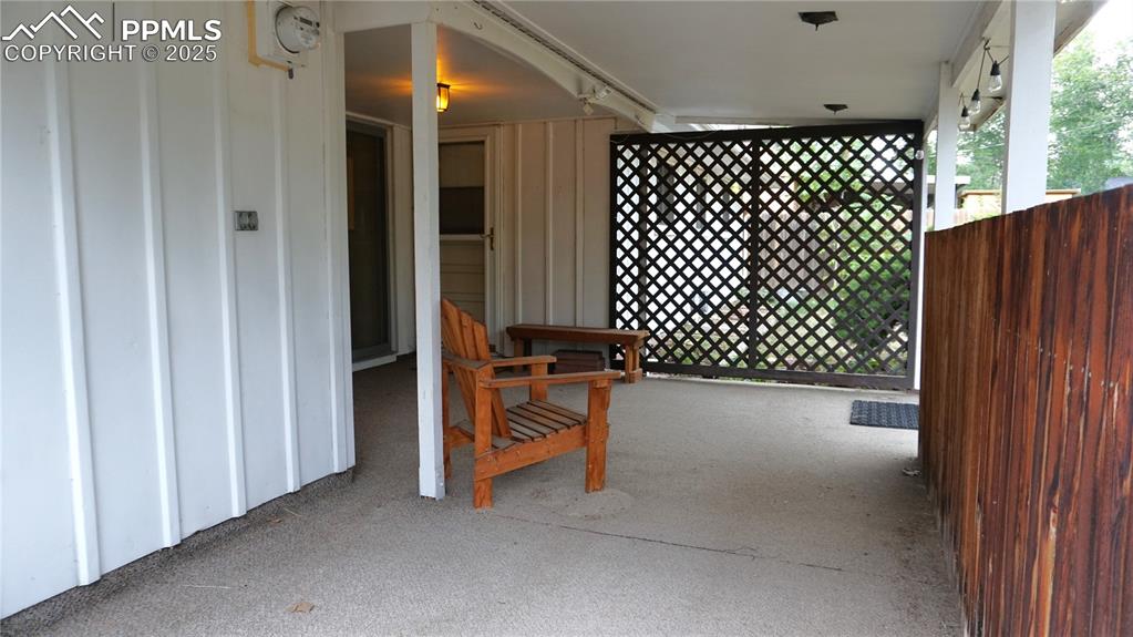 Image 15 of 23: Covered patio with doors to dining room and kitchen