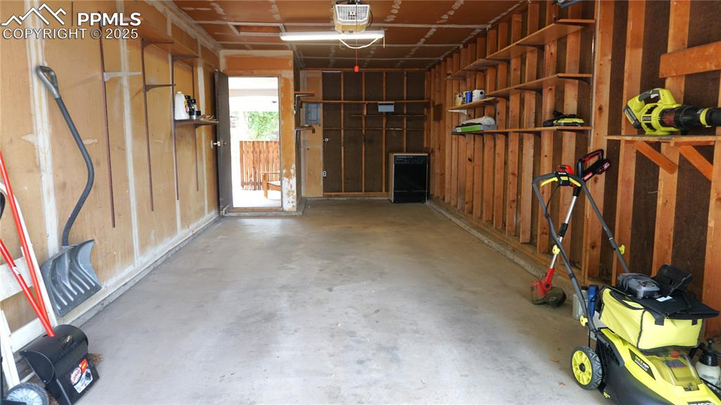Image 17 of 23: Oversized one-car garage has room for extra storage, a workbench, or a deep