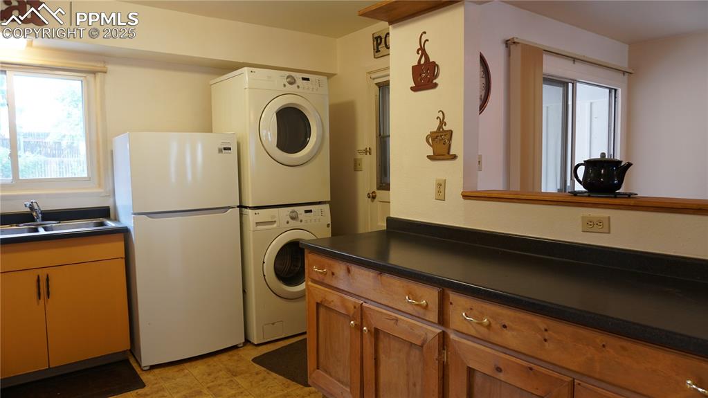 Image 8 of 23: Kitchen with handy laundry and door to the patio