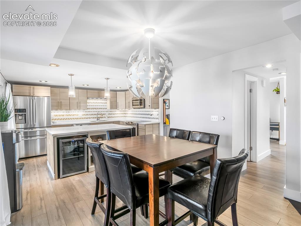 Image 11 of 29: Open and inviting dining space flows seamlessly into the updated kitchen, c