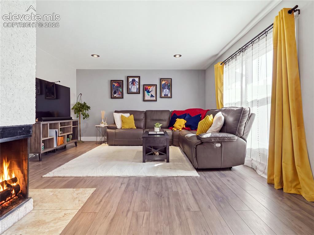 Image 12 of 29: Inviting family room with a cozy fireplace and plenty of space to relax or