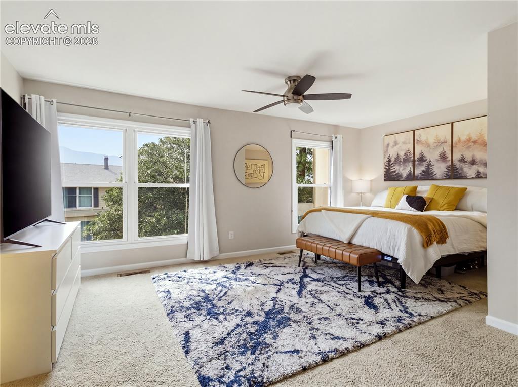Image 17 of 29: Wall-to-wall carpeting and a ceiling fan with integrated lighting