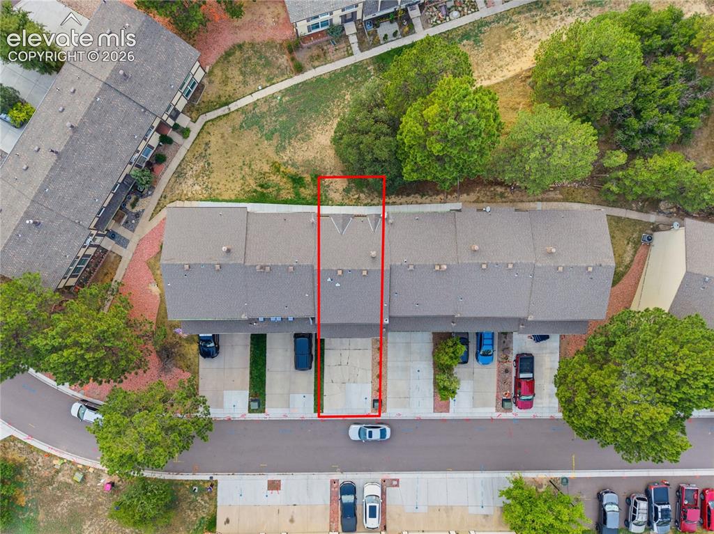 Image 25 of 29: Attached two-car garage with concrete flooring, finished walls, and a white