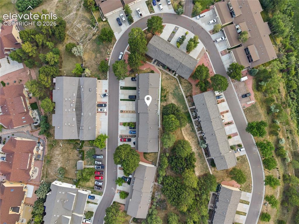 Image 27 of 29: Mountain backdrop framing a residential development with natural landscapin