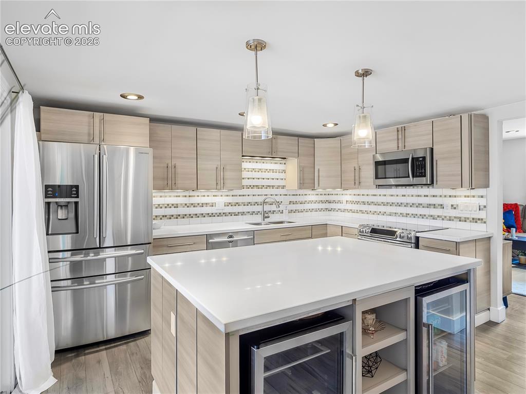 Image 8 of 29: Beautifully updated kitchen featuring a generous center island, abundant ca