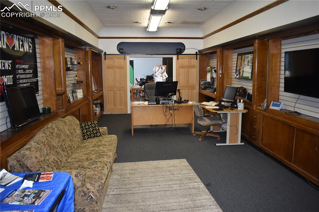 Image 13 of 37: Home office featuring dark colored carpet