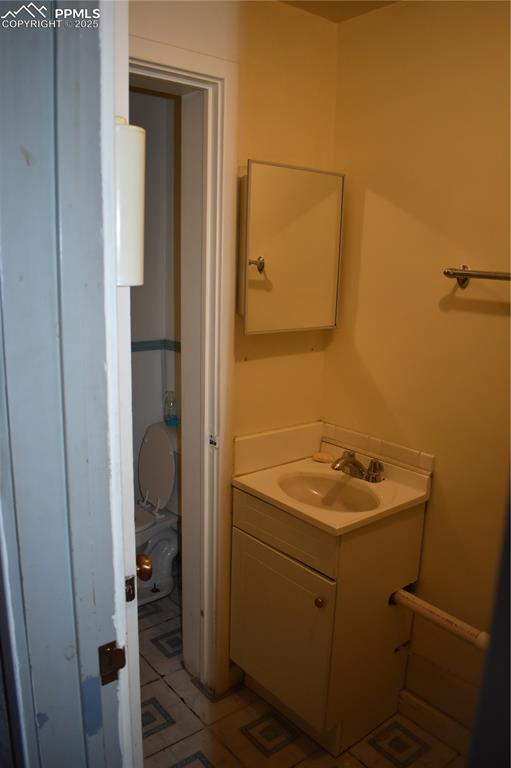 Image 18 of 37: Bathroom with vanity and light tile patterned floors