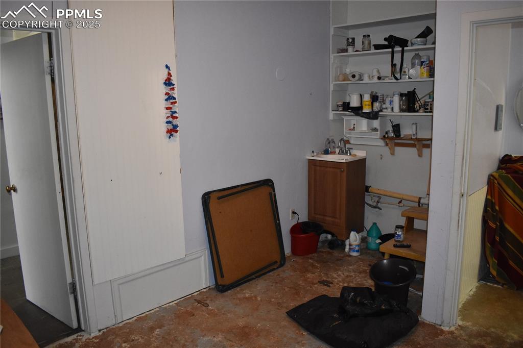 Image 26 of 37: Bedroom with concrete floors