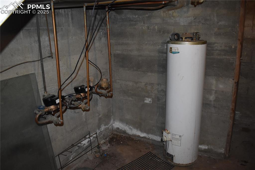 Image 34 of 37: Unfinished basement featuring water heater