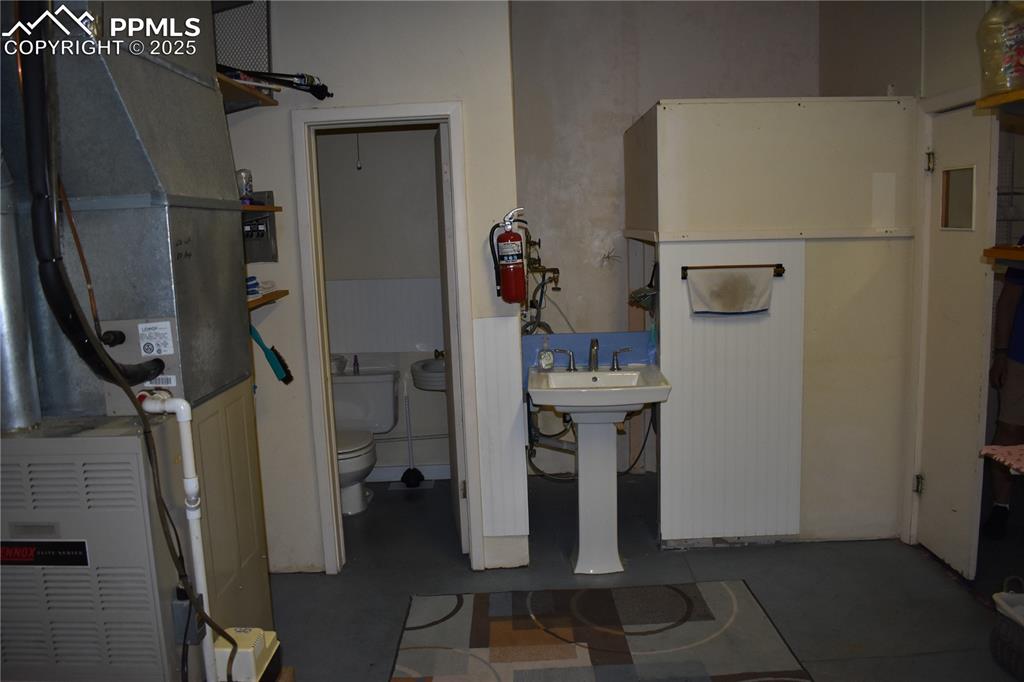 Image 37 of 37: Bathroom featuring heating unit and toilet