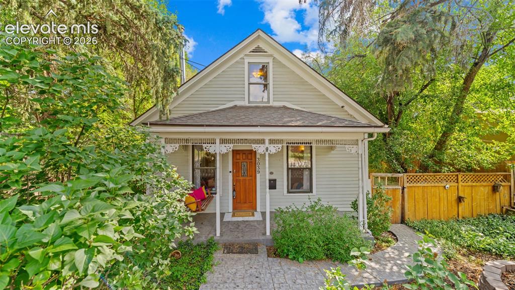 Image 1 of 38: Charming cottage-style home featuring light-colored siding, an inviting fro