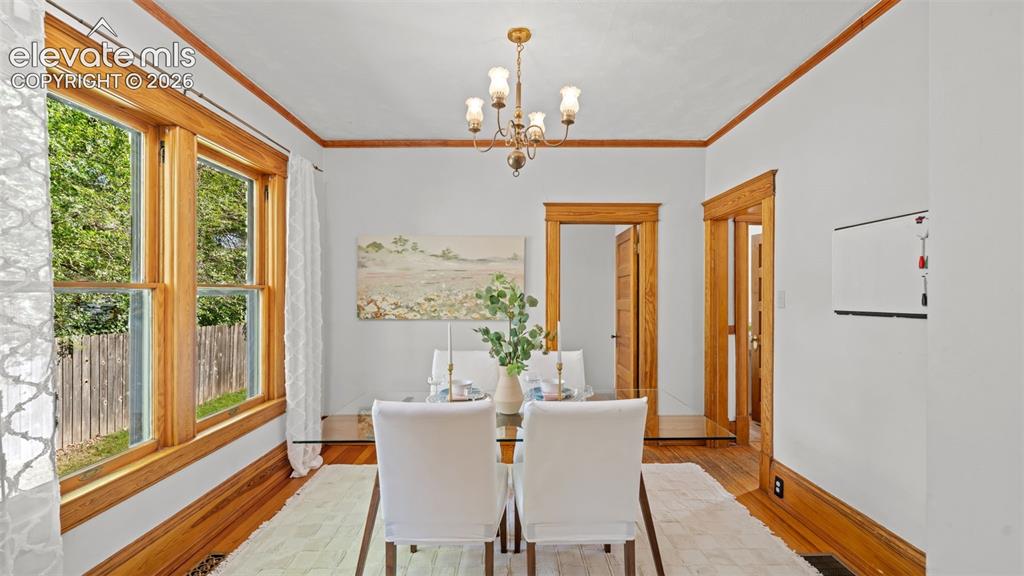 Image 10 of 38: Dining area featuring wood-finish flooring, white walls, and extensive natu