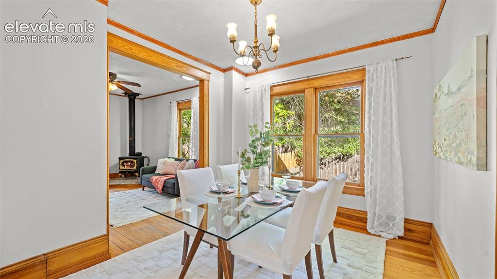 Image 11 of 38: Dining area featuring wood-finish flooring and a brass chandelier