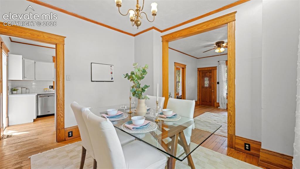 Image 12 of 38: Dining area featuring wood-finish flooring, white walls, and wood trim deta