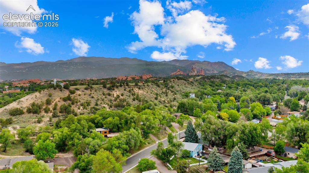 Image 30 of 38: Expansive natural landscape featuring lush green trees, distant mountain ra