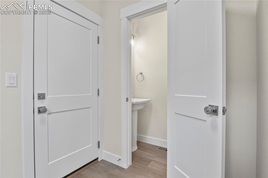 Image 14 of 42: Powder bath and mudroom