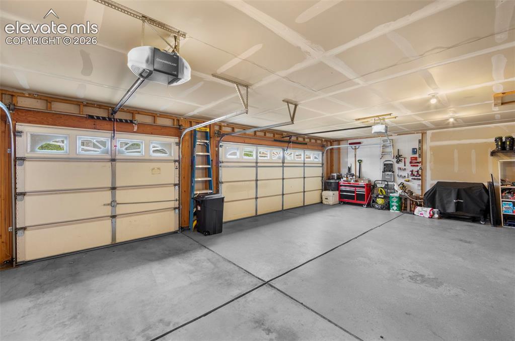 Image 17 of 41: Spacious two-car garage featuring a concrete floor, two individual garage d