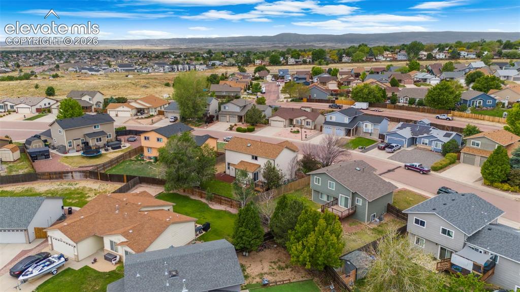 Image 37 of 41: Residential neighborhood with established homes, paved streets, and varied