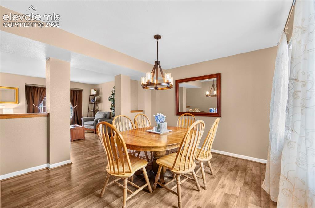 Image 9 of 41: Dining area featuring wood-finish flooring, neutral wall tones, and an over