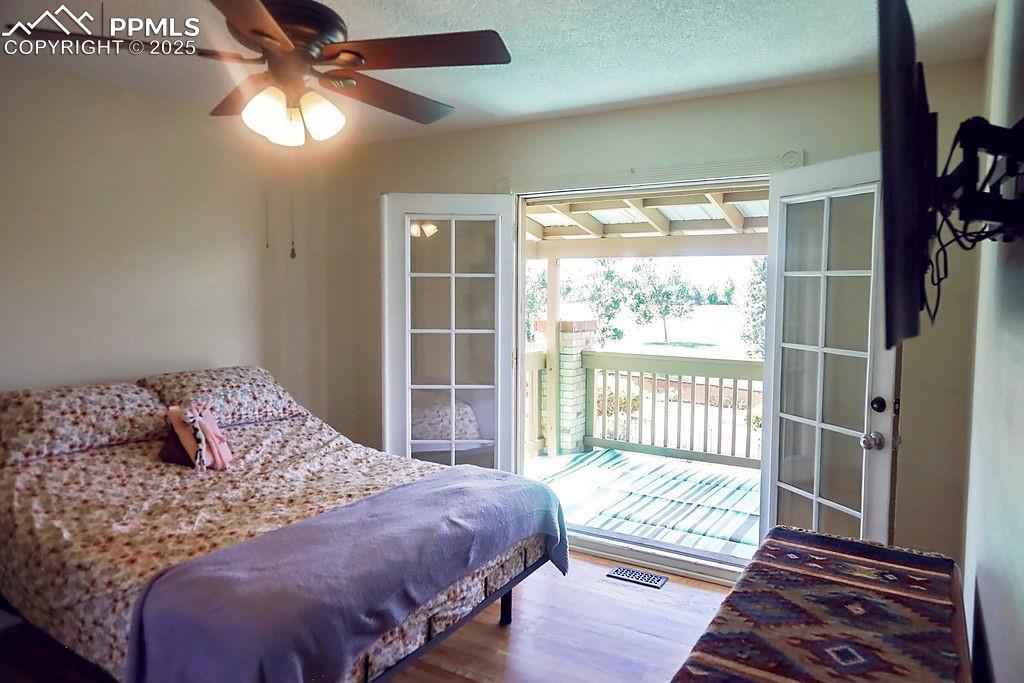 Image 21 of 50: Upper Level Primary Bedroom with Walk-Out to Covered Deck