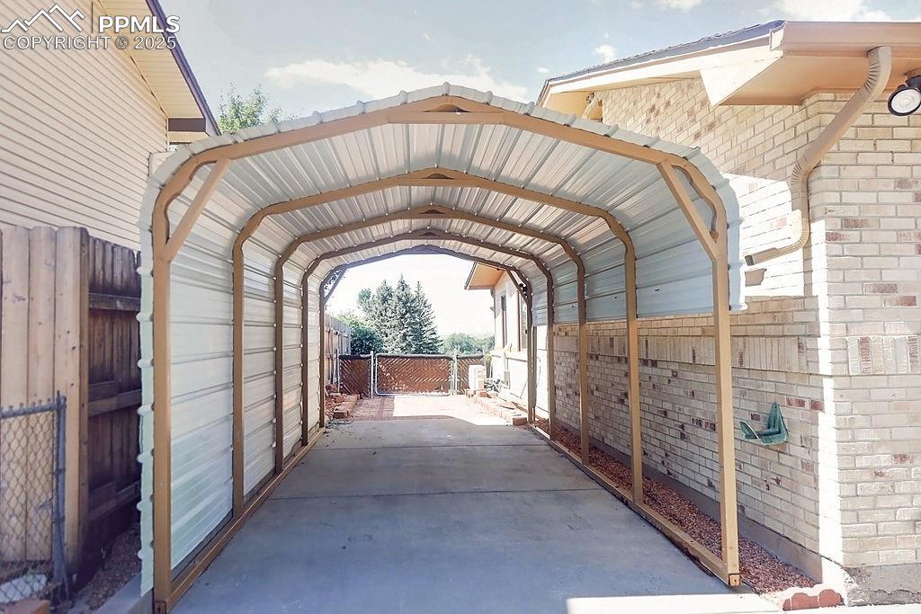 Image 3 of 50: Carport to Backyard