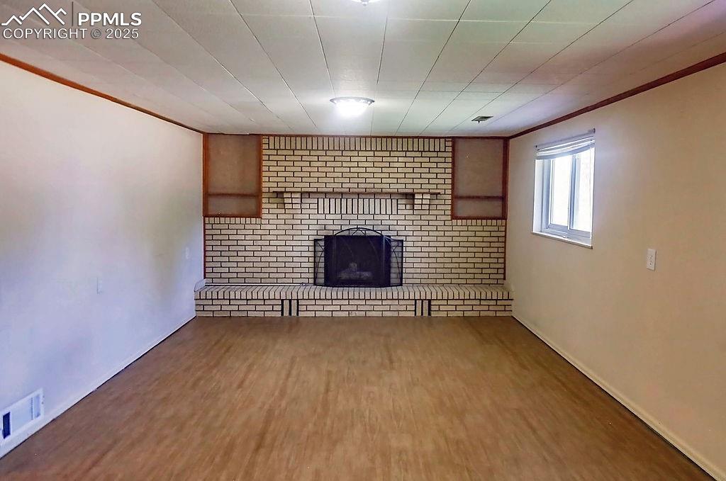 Image 31 of 50: Lower Level Family Room with Fireplace